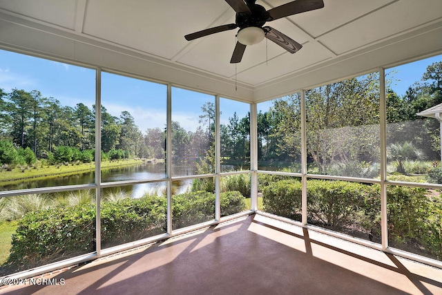 unfurnished sunroom with a water view and ceiling fan