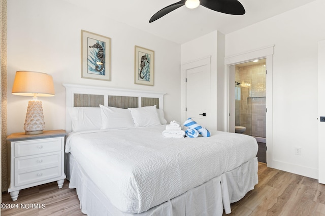 bedroom featuring ensuite bath, light wood-style flooring, baseboards, and ceiling fan