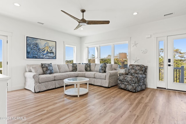 living area featuring recessed lighting, visible vents, and light wood-style floors