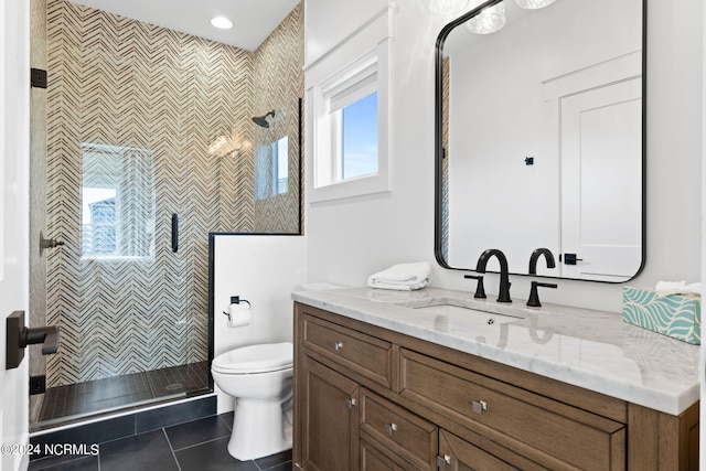 full bathroom featuring toilet, a shower stall, vanity, and tile patterned floors