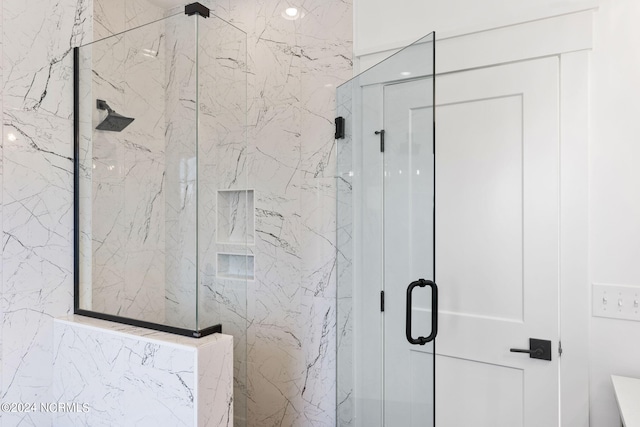 full bath featuring a marble finish shower