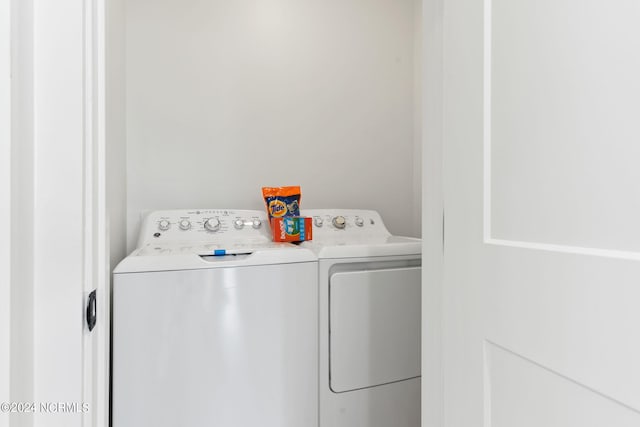 washroom featuring laundry area and washing machine and clothes dryer