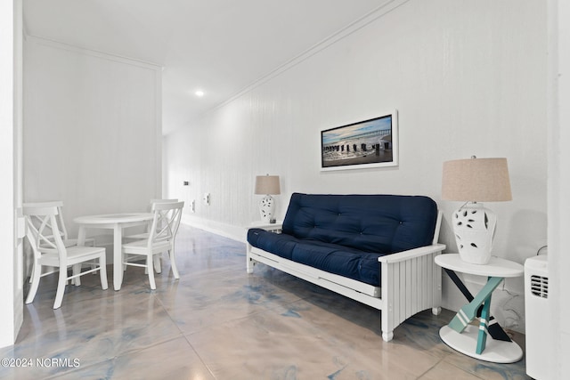 sitting room with concrete flooring, recessed lighting, and crown molding