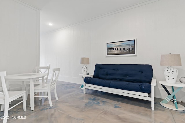 sitting room with concrete flooring, crown molding, and recessed lighting