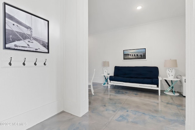 sitting room featuring ornamental molding, concrete floors, and recessed lighting