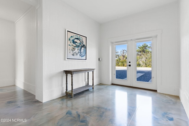 entryway featuring concrete floors and french doors