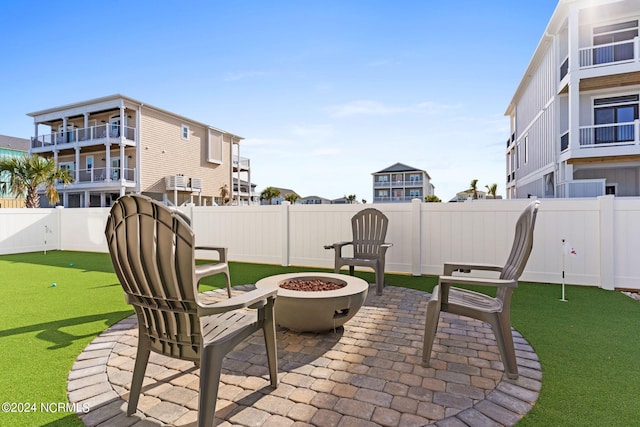 view of patio / terrace with a fenced backyard and a fire pit