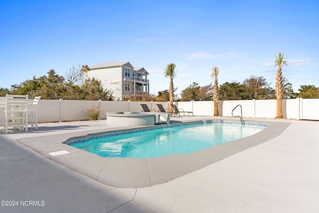 view of pool featuring a fenced in pool, a patio area, a fenced backyard, and an in ground hot tub