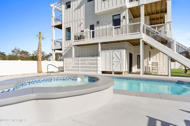 view of swimming pool with a patio area, fence, stairway, and a fenced in pool