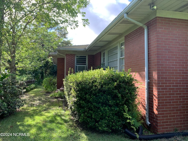 view of property exterior featuring a lawn