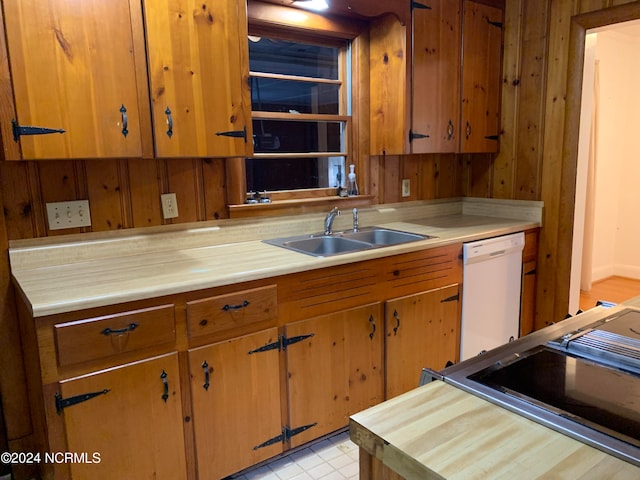 kitchen with white dishwasher, stainless steel range, and sink