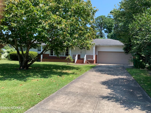 obstructed view of property with a porch, a garage, and a front yard