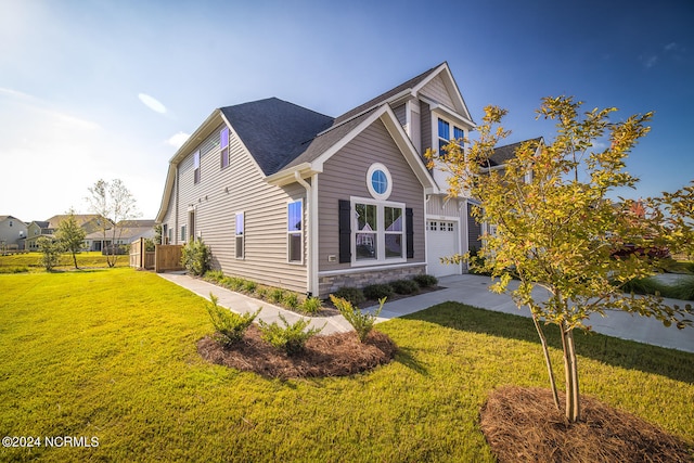 view of front of home with a front yard and a garage