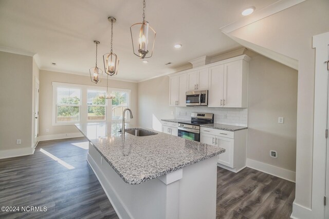 kitchen featuring white cabinetry, stainless steel appliances, dark hardwood / wood-style flooring, pendant lighting, and a kitchen island with sink