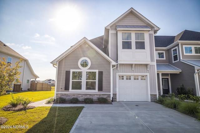 view of front of property featuring a garage and a front lawn