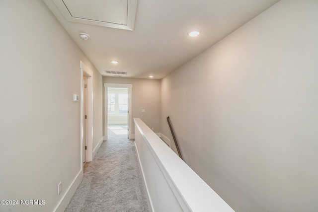 hallway featuring light carpet