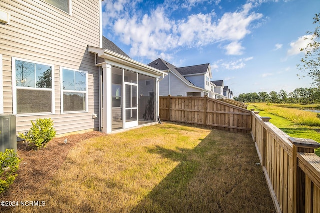 view of yard with a sunroom and cooling unit