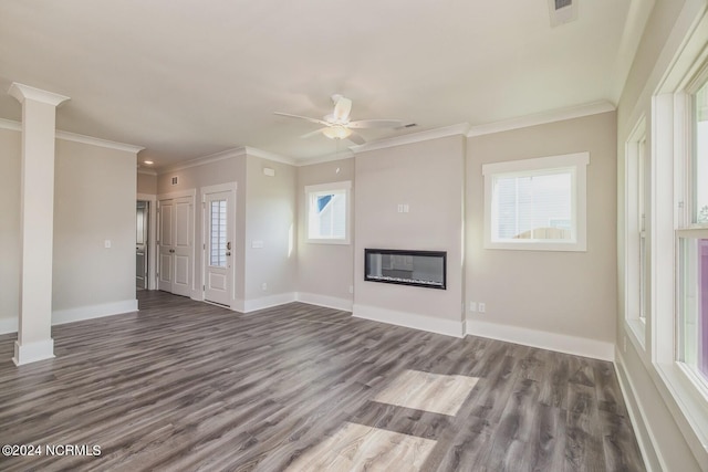 unfurnished living room with ceiling fan, dark hardwood / wood-style flooring, and crown molding