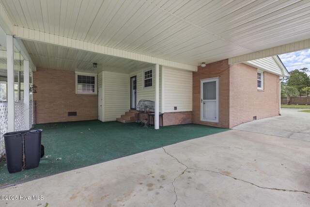 view of patio featuring entry steps and a carport