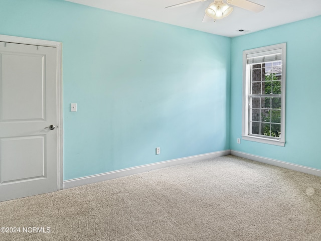 empty room featuring carpet flooring and ceiling fan