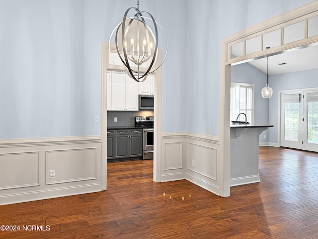 interior space featuring lofted ceiling, an inviting chandelier, sink, and dark hardwood / wood-style floors