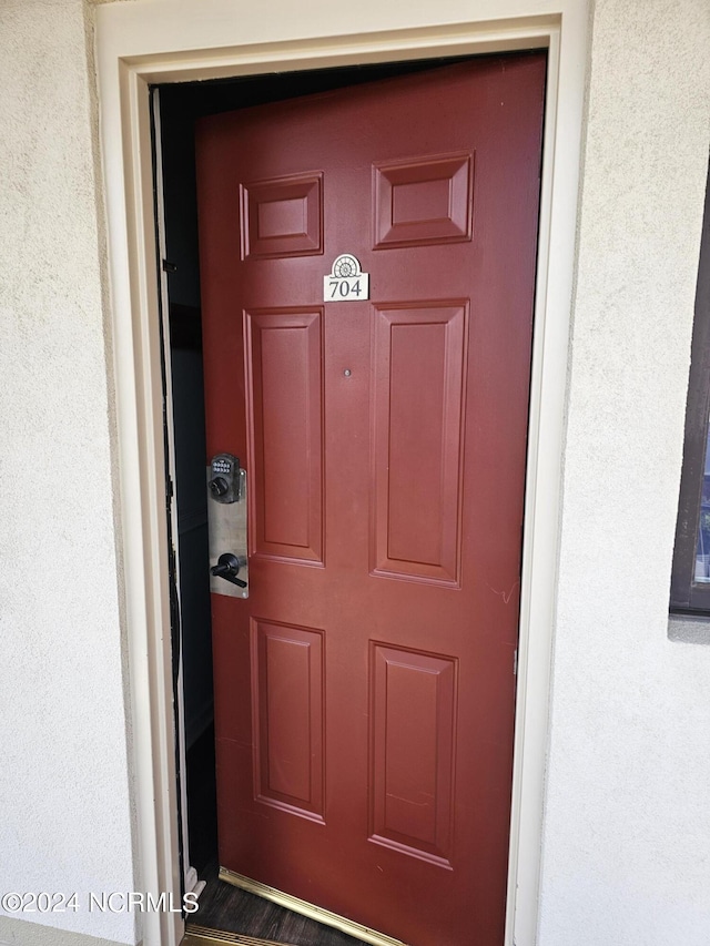 property entrance with stucco siding