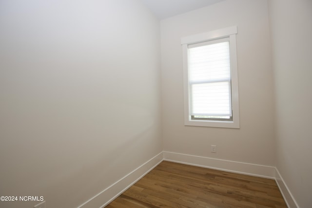 spare room with dark wood-type flooring