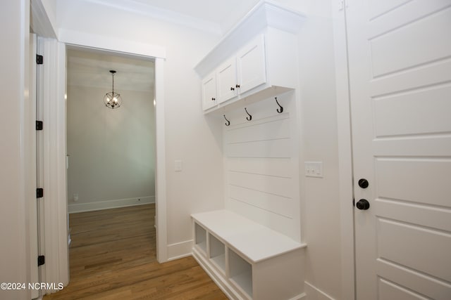 mudroom featuring a notable chandelier and light hardwood / wood-style floors