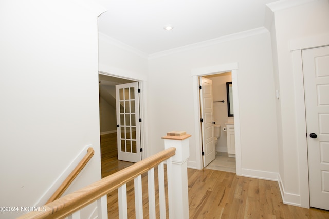 corridor featuring crown molding and light wood-type flooring