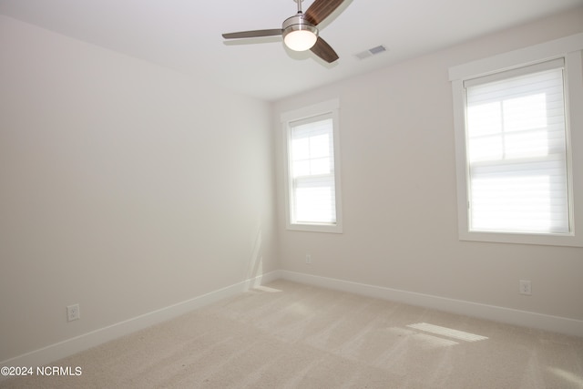 spare room with light carpet and ceiling fan