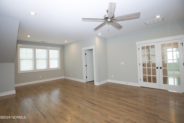 empty room with ceiling fan, wood-type flooring, and french doors