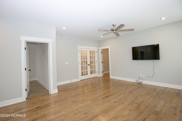 unfurnished living room with ceiling fan, hardwood / wood-style flooring, and french doors