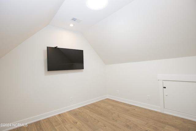 bonus room featuring light hardwood / wood-style flooring and vaulted ceiling