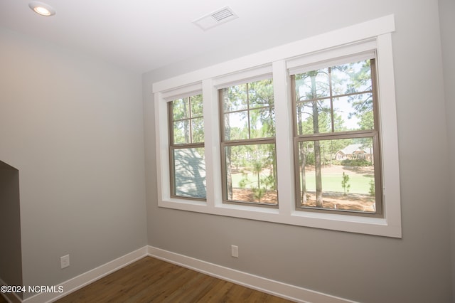 unfurnished room featuring dark hardwood / wood-style flooring