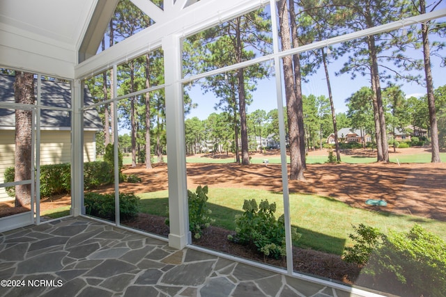 unfurnished sunroom with lofted ceiling