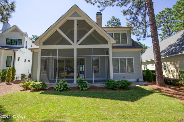 exterior space with a sunroom and a yard