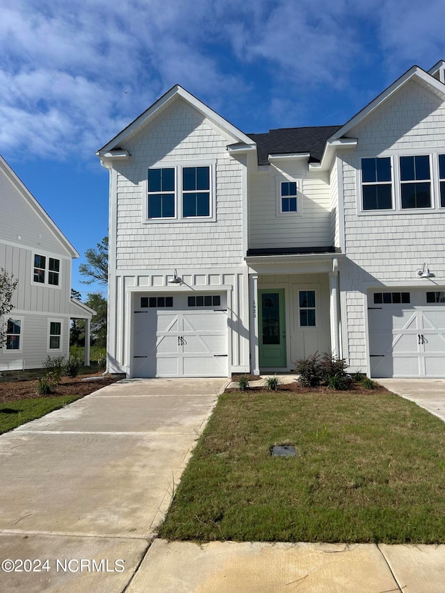 view of front of house with a garage and a front yard