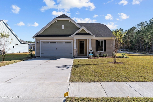 view of front of property featuring a garage and a front lawn