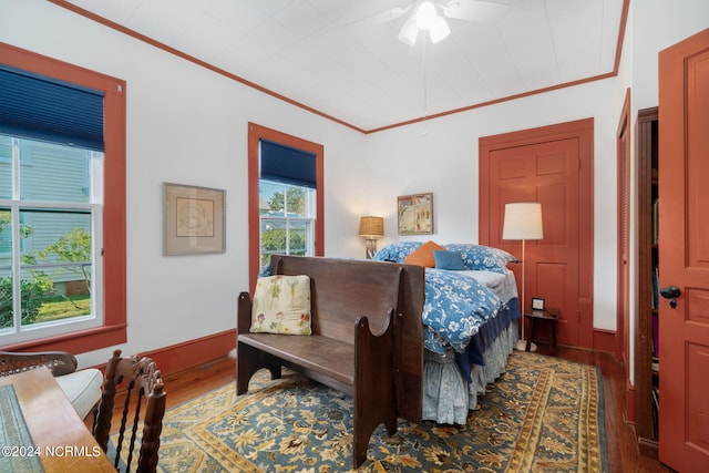 bedroom featuring ornamental molding, dark hardwood / wood-style floors, and ceiling fan