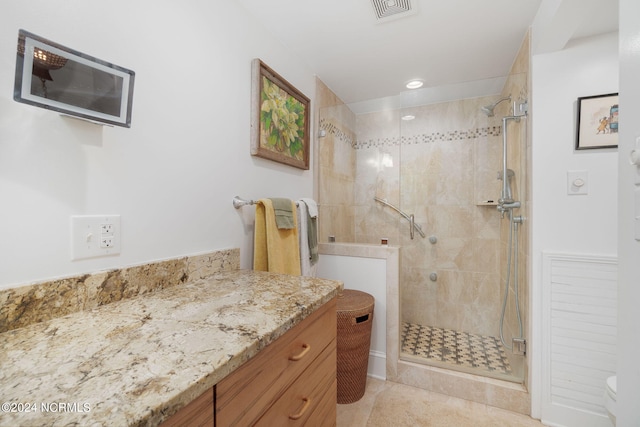 bathroom featuring vanity, tile patterned floors, and walk in shower