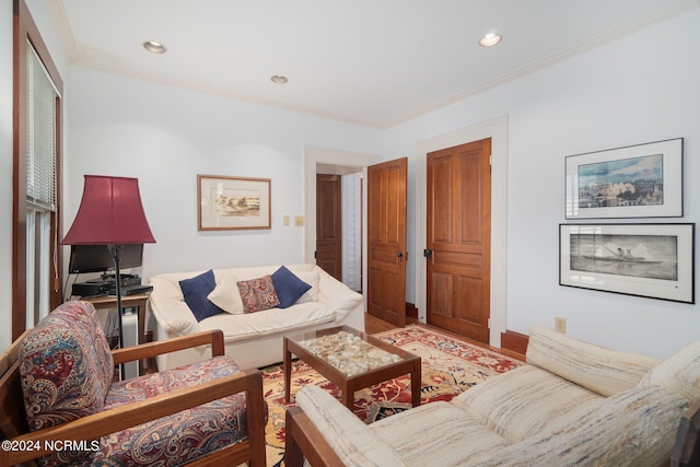 living room with light hardwood / wood-style floors and crown molding