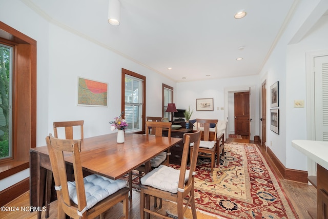 dining space featuring crown molding and hardwood / wood-style floors