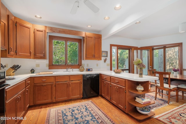 kitchen featuring kitchen peninsula, dishwasher, beam ceiling, and a wealth of natural light