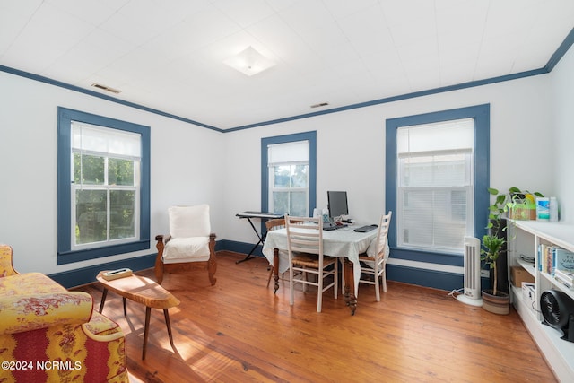 home office with ornamental molding and wood-type flooring