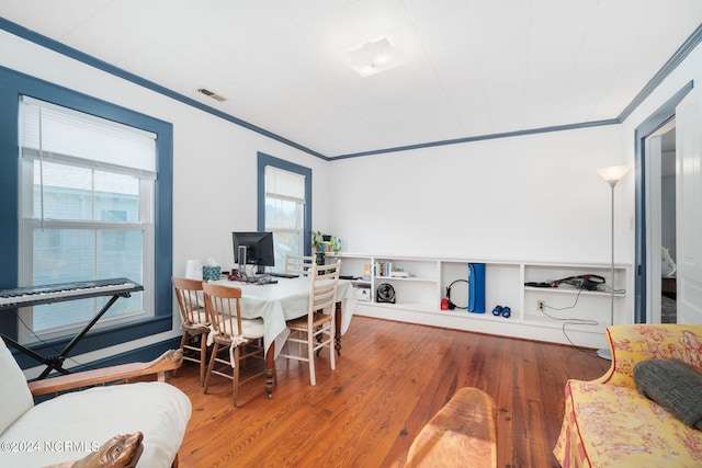 home office featuring ornamental molding and hardwood / wood-style floors