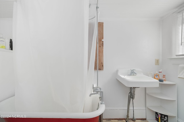 bathroom featuring shower / tub combo with curtain and ornamental molding