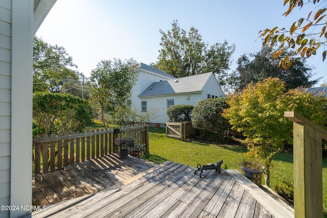 wooden terrace featuring a lawn