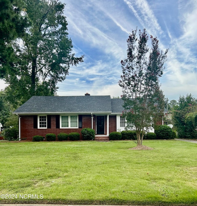 ranch-style home with a front lawn