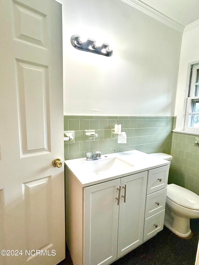 bathroom with backsplash, toilet, tile walls, vanity, and ornamental molding