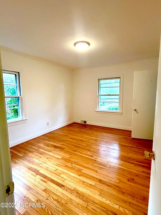 spare room featuring light hardwood / wood-style floors